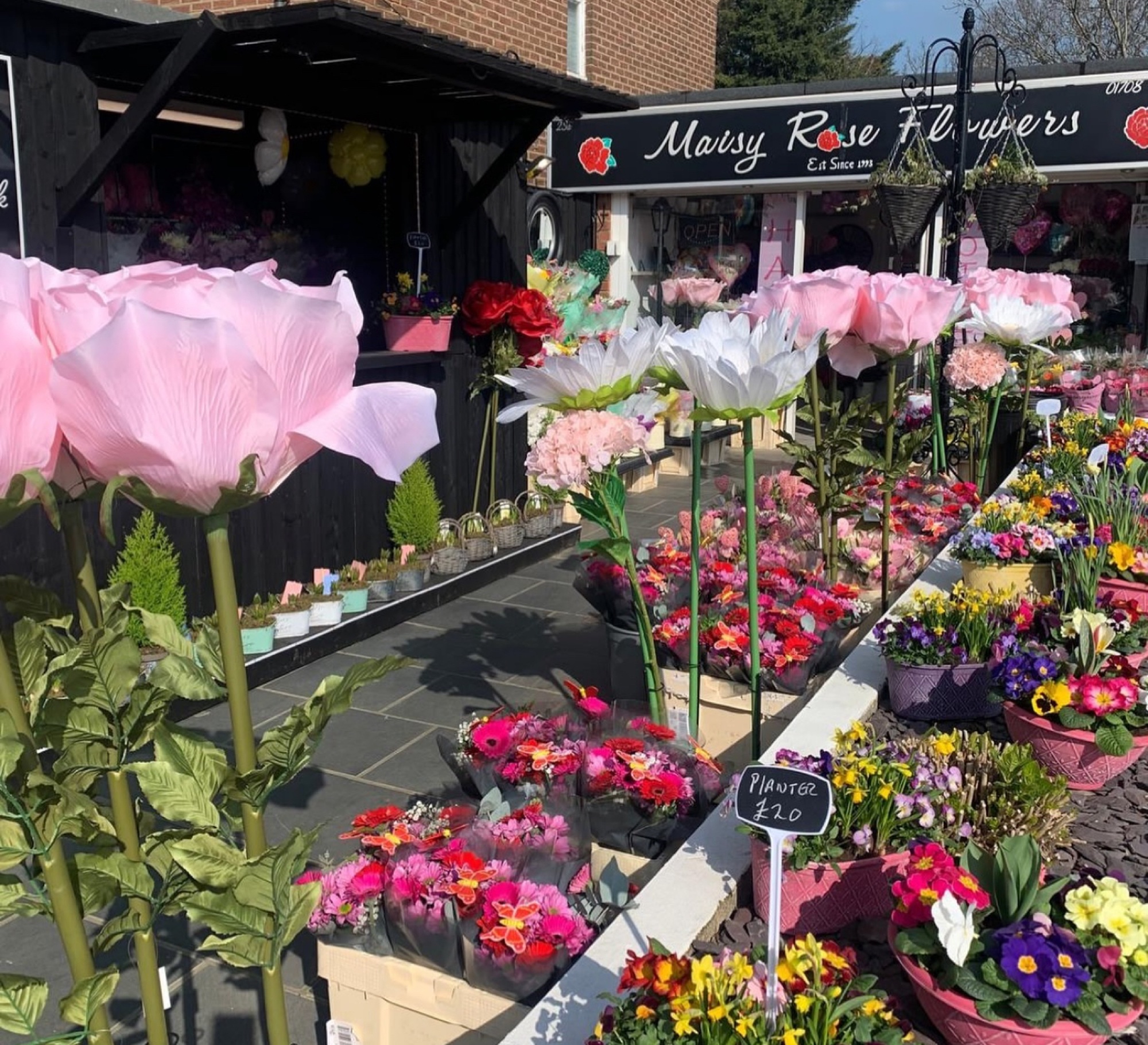 Spring storefront with giant paper-flower display