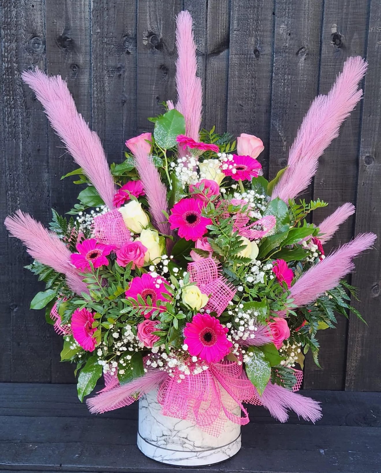 Pink gerbera with pampas grass arrangement